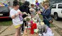 People gather at a memorial in Erie, Pa., Sunday, Oct. 11, 2026, outside the home where authorities say a gunman killed several people before killing himself on Oct. 9.