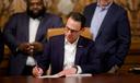 Gov. Josh Shapiro signs the final pieces of the 2023 Pennsylvania budget in the Capitol.