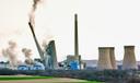 The smokestacks of the former coal-fired Homer City Generating Station crumble in a planned demolition in Homer City, Pa.