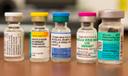 Vials containing vaccines for measles, hepatitis B, polio, and other diseases.