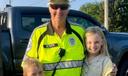 Crossing guard Jan Weaver hugs two children