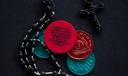 A photo of a rosary and sobriety chips.