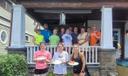 Mayor Michele Bannon (third from right in top row) poses with Group Mission Trips volunteers at a small home repairs project in Carbondale.