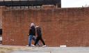 People walk past locations of the now removed explanatory panels that were part of an exhibit on slavery.
