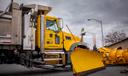 A PennDOT snow plow in a parking lot