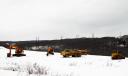 A high-voltage powerline runs behind a construction site in Archbald, PA.