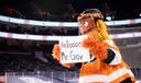 Philadelphia Flyers mascot Gritty welcoming Gov. Tom Wolf to a press conference in 2021.