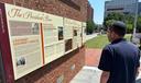 Visitors view the reinstalled educational panels about slavery at the site of President George Washington's home in Philadelphia, Wednesday, July 15, 2026.