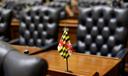 A miniature Maryland flag stands on a desk in the Maryland House of Delegates in Annapolis, Md., Wednesday, Jan. 14, 2015, the first day of the 2015 legislative session.