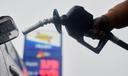 A motorist removes the pump from his car at a gas station, in Philadelphia, Tuesday, March 3, 2026.