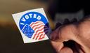 A voter holds an “I Voted” sticker Nov. 8, 2022, at Memorial Hall in Jim Thorpe Carbon County, Pennsylvania.