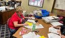 Marcie Strachko, Columbia County’s human resources director, processes mail ballots during the 2023 municipal primary.