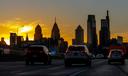 The sun sets behind City Hall and the Philadelphia skyline Dec. 3, 2021, photographed on southbound Interstate I-95, just north of Center City.