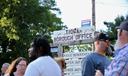 People stand in front of the sign for Tioga borough’s office.