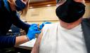 Amber Pedro, a volunteer from Family Practice Laporte, administers the vaccine into the arm of Robert Keen, 84 of Forksville, in the cafeteria of the Sullivan County Elementary School.