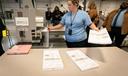 Philadelphia Election Clerk Lisa Gogel demonstrates a ballot scanner that will be used in the 2022 election in Pennsylvania.