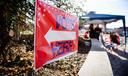 A sign directing people to "vote here" is seen in Camp Hill, Pennsylvania on midterm Election Day 2022.