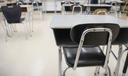 Desks are shown in a classroom.