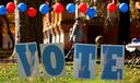 Students on the campus of the University of Pittsburgh walk past a ‘vote’ sign on Election Day, Nov. 5., 2024.