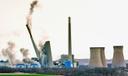 The smokestacks of the former coal-fired Homer City Generating Station crumble in a planned demolition to make way for a new natural gas-fired power plant.