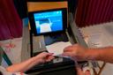 A polling judge helps guide a voter's ballot into a voting machine during the May 2022 Pennsylvania primary election. A polling judge helps guide a voter's ballot into a voting machine during the May 2022 Pennsylvania primary election.
