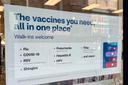 A flyer advertising vaccine services outside a CVS in Downtown Pittsburgh.