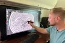 Medallic artist Eric David Custer at his workstation, showing his design for the tails side of the semiquincentennial dime on a computer screen.