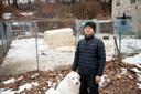Ge Fangyuan, a farmer in Washington Township, stands with his dog for a portrait at the farm Feb. 20, 2026. Fangyuan's farm was disrupted after a sewer main break dumped about 8,000 gallons of raw sewage in November 2024.