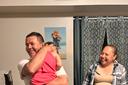 Erasmo Zavala hugs his granddaughter, Selene, as his wife Maria stands nearby. A picture of Selene’s mother, Selena, who was murdered, hangs behind the family. May 29, 2026.