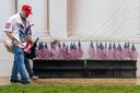 A man and woman in "Trump" hats walk through the Great American State Fair on the National Mall, in Washington.