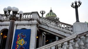 The Pennsylvania flag is seen hanging on the east side of the state Capitol building in Harrisburg.