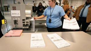Philadelphia Election Clerk Lisa Gogel demonstrates a ballot scanner that will be used in the 2022 election in Pennsylvania.