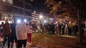 Pennsylvania State Police on horseback try to control a crowd on Penn State's campus. Pennsylvania State Police on horseback try to control a crowd on Penn State's campus.