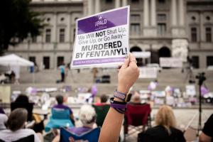People gather on the steps of the Pennsylvania State Capitol in Harrisburg to honor lives lost to addiction during 2021's Overdose Awareness & Memorial Day.