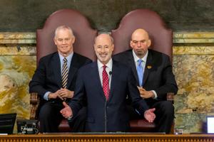 Pennsylvania Gov. Tom Wolf delivers his 2020-21 budget address in the state House of Representatives as Speaker Mike Turzai, left, and Lt. Gov. John Fetterman, right, look on, on Feb. 4, 2020, in Harrisburg, Pa