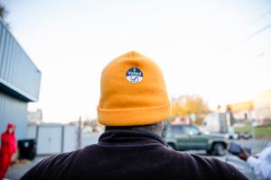 Photo of the back of a person's hat with an I Voted sticker