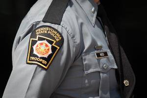 A Pennsylvania State Police Trooper patch on the uniform of a trooper.