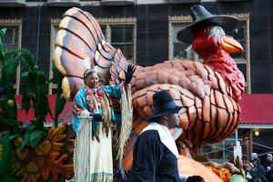 Parade participants wave from a turkey-shaped float at the 98th Annual 6ABC Dunkin' Donuts Thanksgiving Day Parade.
