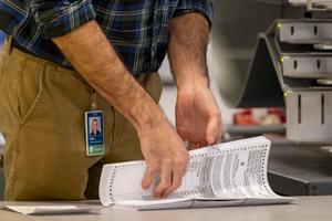 A worker preparing 2022 ballots in Philadelphia. A new bill would give counties more time to prep these ballots.