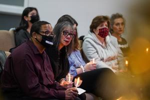 Gareth Hall, left, and his wife Fe Hall, right, look on during a vigil for their late son Christian Hall in December. Their lawsuit claims troopers used excessive force, killing Hall as he tried to surrender and after they said they would not shoot him.