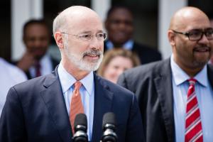Gov. Tom Wolf (left) signed an order that directed the Department of Corrections, led by Secretary John Wetzel (right), to create a reprieve program for medically vulnerable inmates convicted of nonviolent crimes.