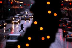 Pedestrians cross South Broad Street in Philadelphia during a rainy winter storm in October of 2022.