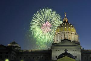 Fireworks explode over the Pennsylvania state Capitol building.