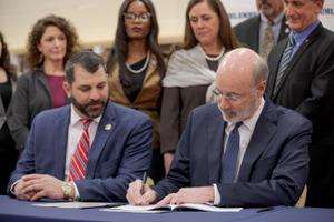 Gov. Tom Wolf (right) signed a bill in 2019 regarding child victims of sex abuse while Mark Rozzi looked on.