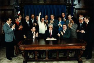 Deb Beck (center back) celebrates as Gov. Bob Casey Sr. (center front) signed Act 152 into law in 1988. The law required public insurance to cover drug and alcohol addiction treatment, an expansion of a previous law championed by Beck.