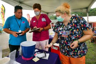 Luis Angel Guzman, a 19-year-old carnival ride worker from Mexico, talks with Wayne Memorial Community Health Center nurses at the Wayne County Fair before he got the Johnson & Johnson vaccine. Luis Angel Guzman, a 19-year-old carnival ride worker from Mexico, talks with Wayne Memorial Community Health Center nurses at the Wayne County Fair before he got the Johnson & Johnson vaccine.