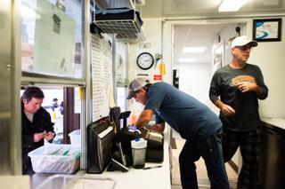 Bob Morris, center, owner of Burgers & More, takes a customer order while working with his brother, Scott Morris, right, at the family burger business in Waynesburg. Morris said he has plans to expand his shop in the summer to also serve ice cream for locals. Bob Morris, center, owner of Burgers & More, takes a customer order while working with his brother, Scott Morris, right, at the family burger business in Waynesburg. Morris said he has plans to expand his shop in the summer to also serve ice cream for locals.