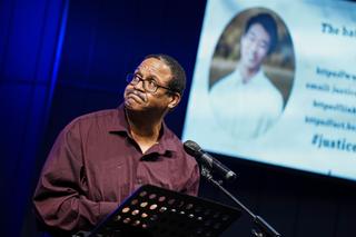 Gareth Hall looks at an image of his late son, Christian, as he speaks during a vigil at Pleasant Valley Assembly of God in Brodheadsville. Christian Hall was killed one year ago by Pennsylvania State Police. 