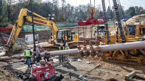 Pipefitters, left, work to connect a long segment of pipe that is being suspended in air to make it ready to be pulled undergroud in a residential area of West Chester, PA on Ship Road and South Pullman Drive as part of the Mariner East Pipeline that is going through the area on November 11, 2019.