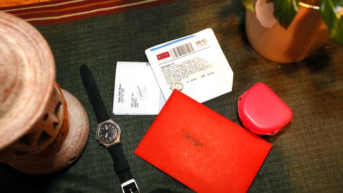 A change wallet, rental DVD, watch, and Christmas card left behind by Christian.